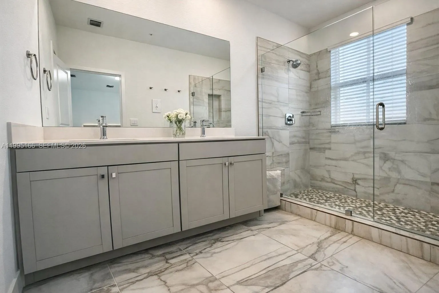Modern primary bathroom with clean finishes and functionality