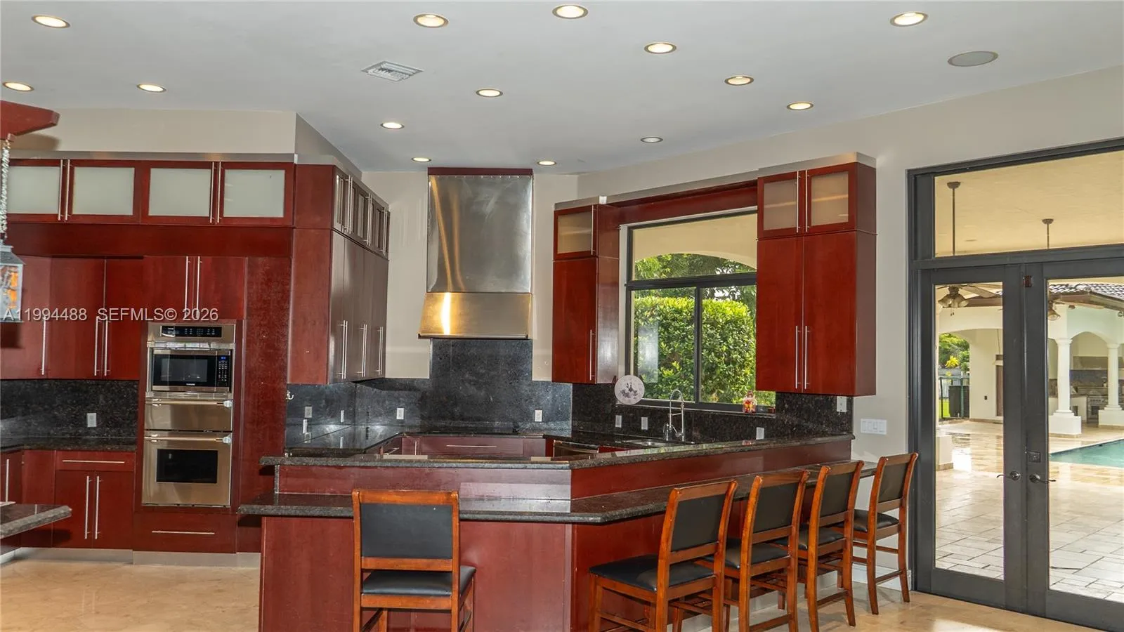 Kitchen opens to a huge family room that has been integrated into the kitchen with lost of light, windows and doors .