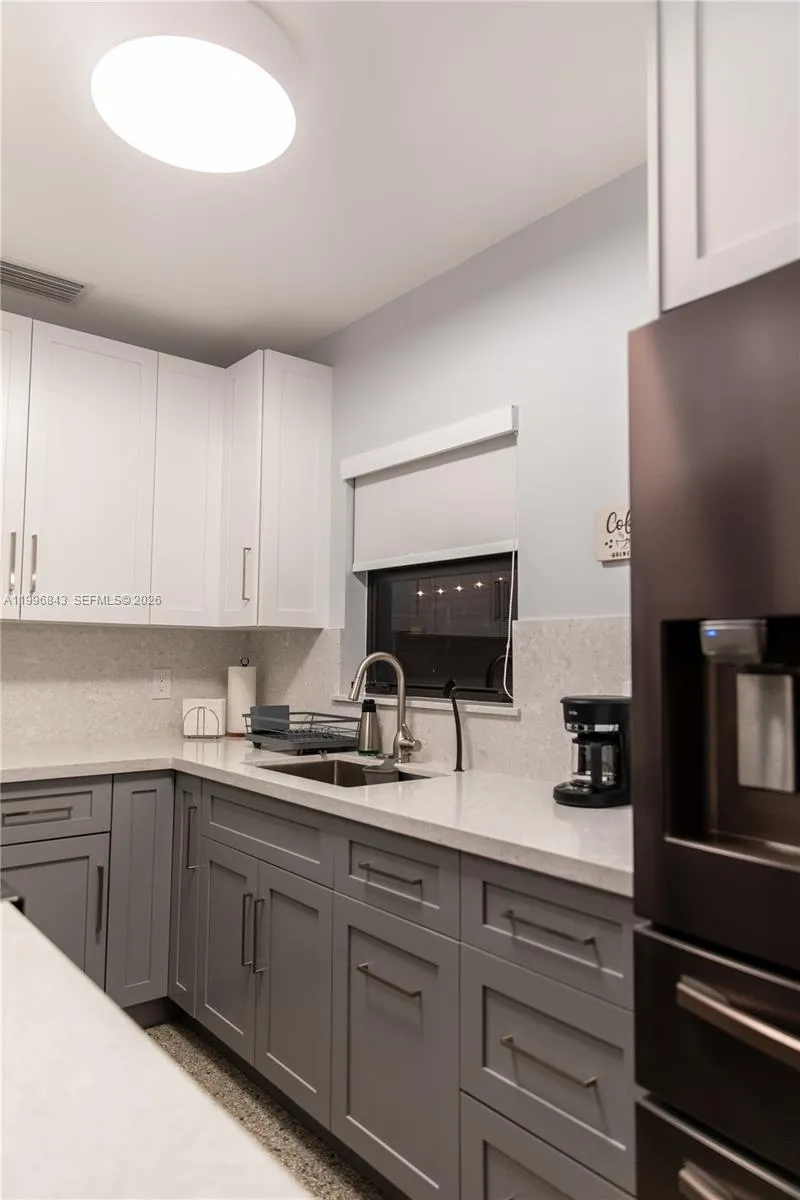“Completely remodeled kitchen featuring modern cabinetry, sleek countertops, and a fresh contemporary design.”