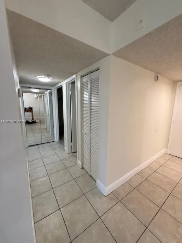 hallway leading to bedrooms and baths