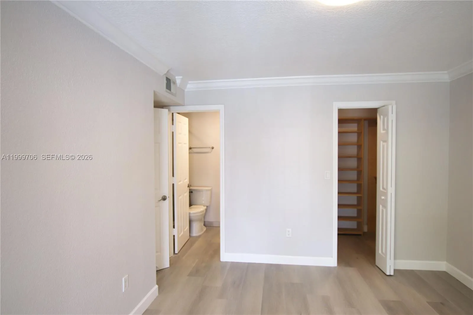 Bedroom, with bathroom on left and walk-in closet on right