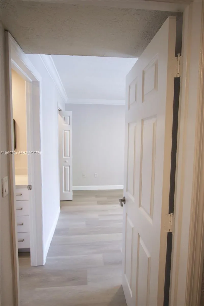 Entering bedroom with updated bathroom on first left and walking in closet further on your left