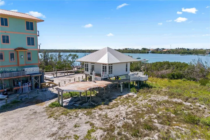 the main home has been demoed and the gest house is all that remains. Electric was brought to the island in the 1980's and each home on the island drills an artesian well and uses septic.