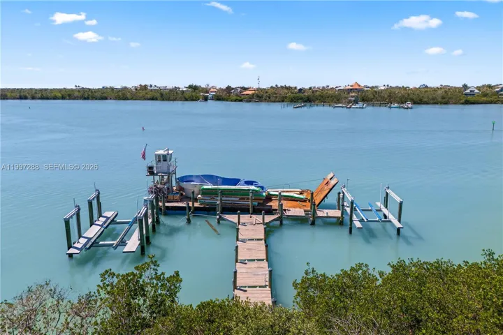 Dock and multiple boatlifts. Check out the view from the back of the home into the bay and back out to the Gulf.
