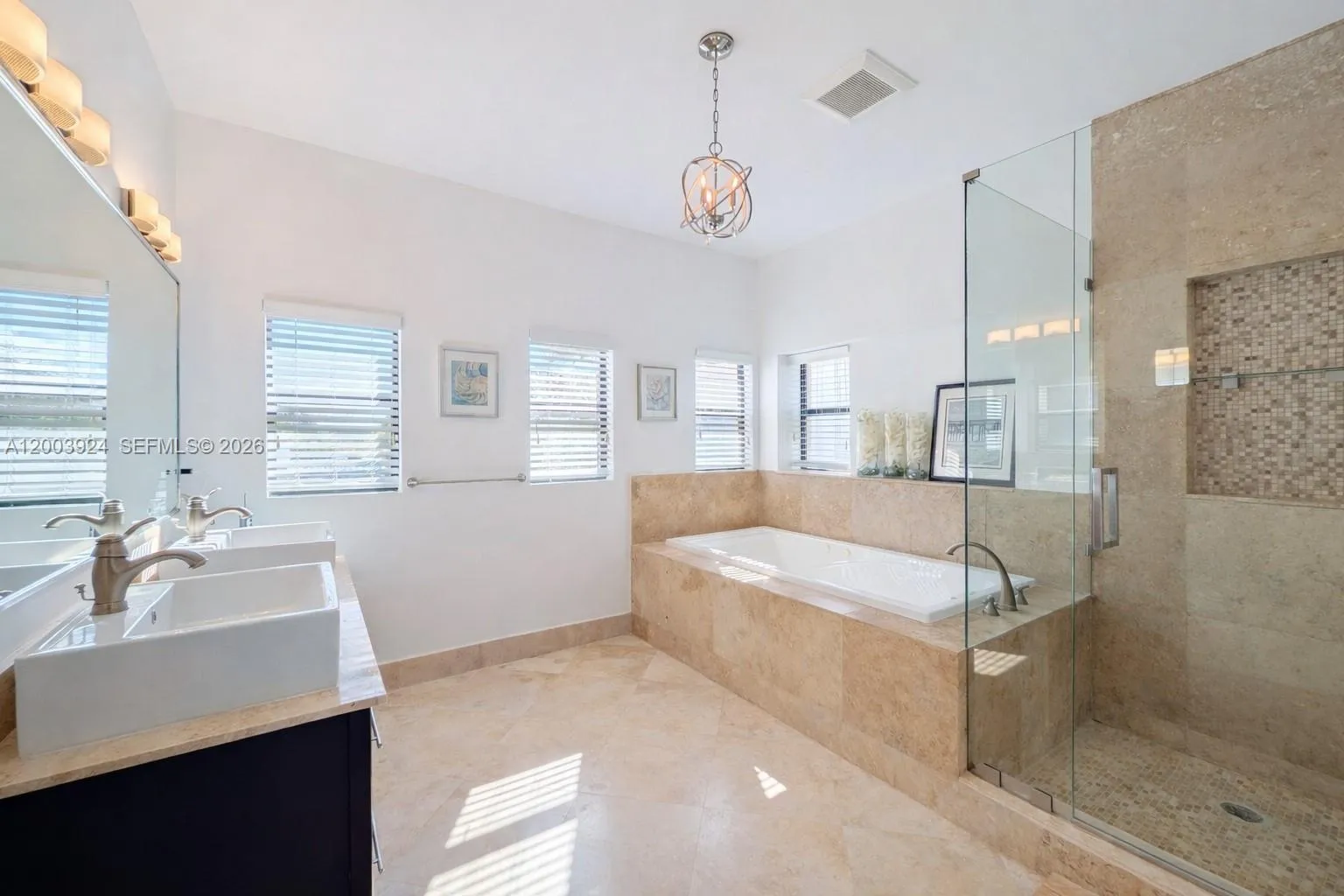 Primary suite bathroom with a whirlpool bath, glass shower, his and her sinks, a Toto bidet and separate conventional toilet.