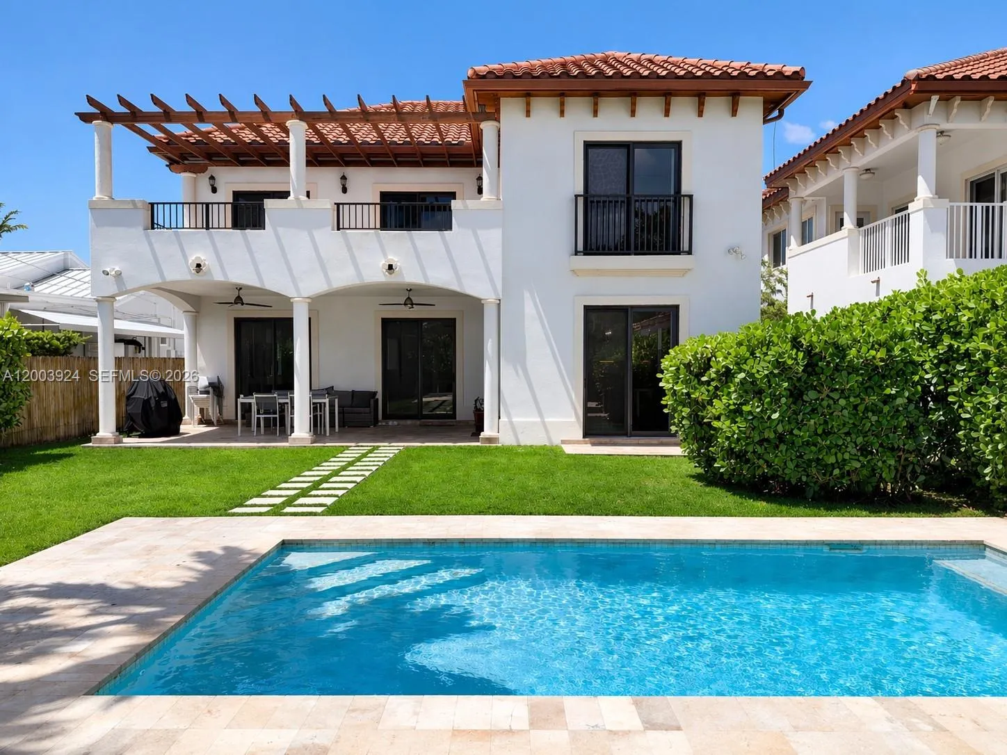 back yard with pool and covered terrace.