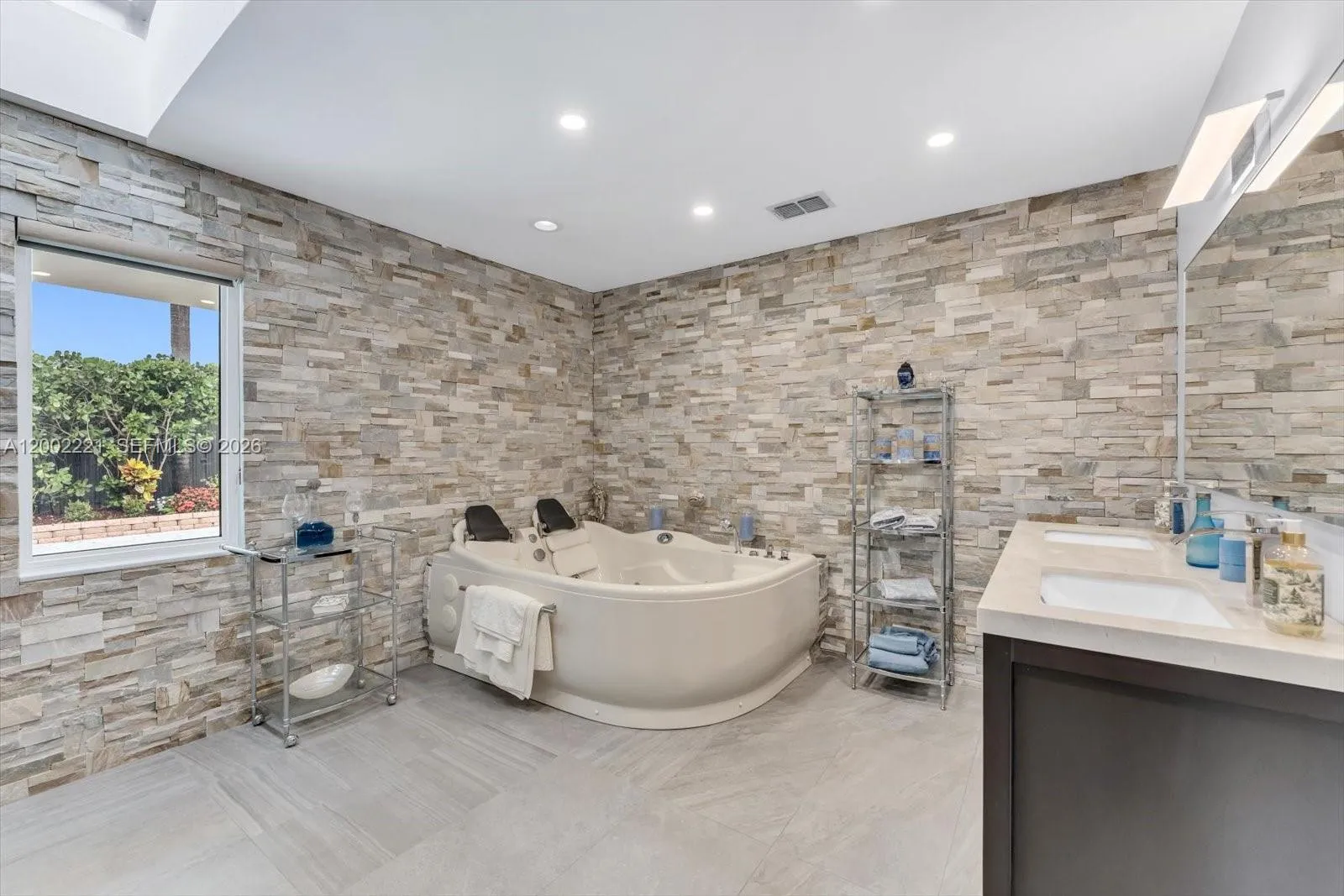 Main bathroom with skylight and spa tub