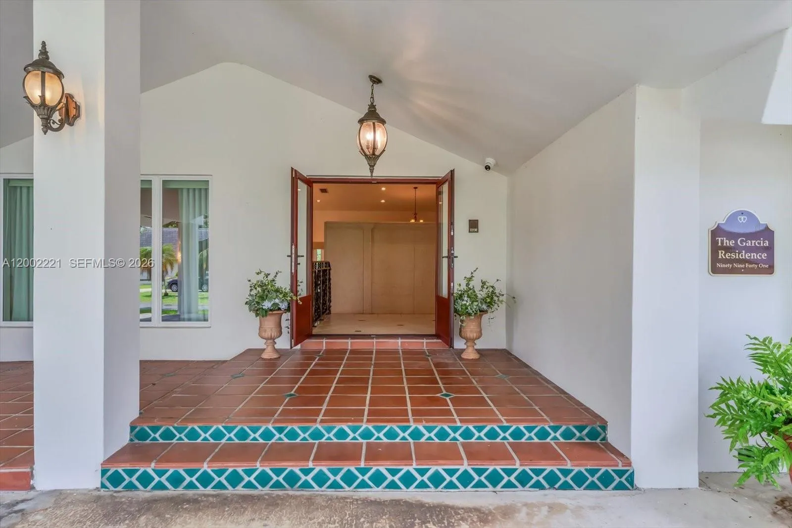 Additional spacious covered entry way into double impact doors