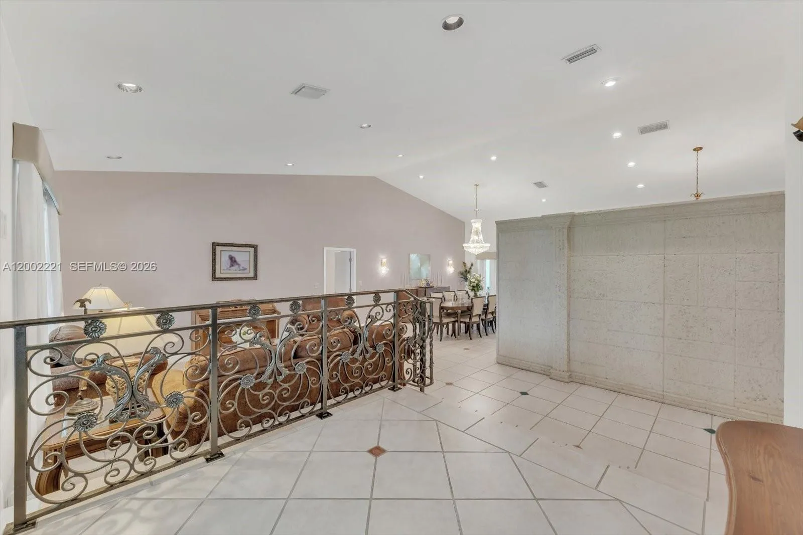 Elegant foyer entry with a custom design wrought iron failing