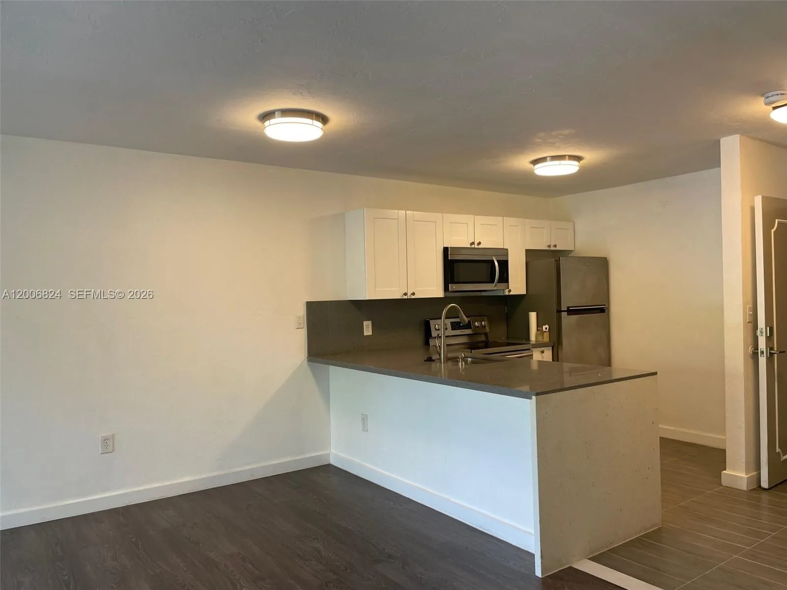 Kitchen with SS Appliances & Solid Counter