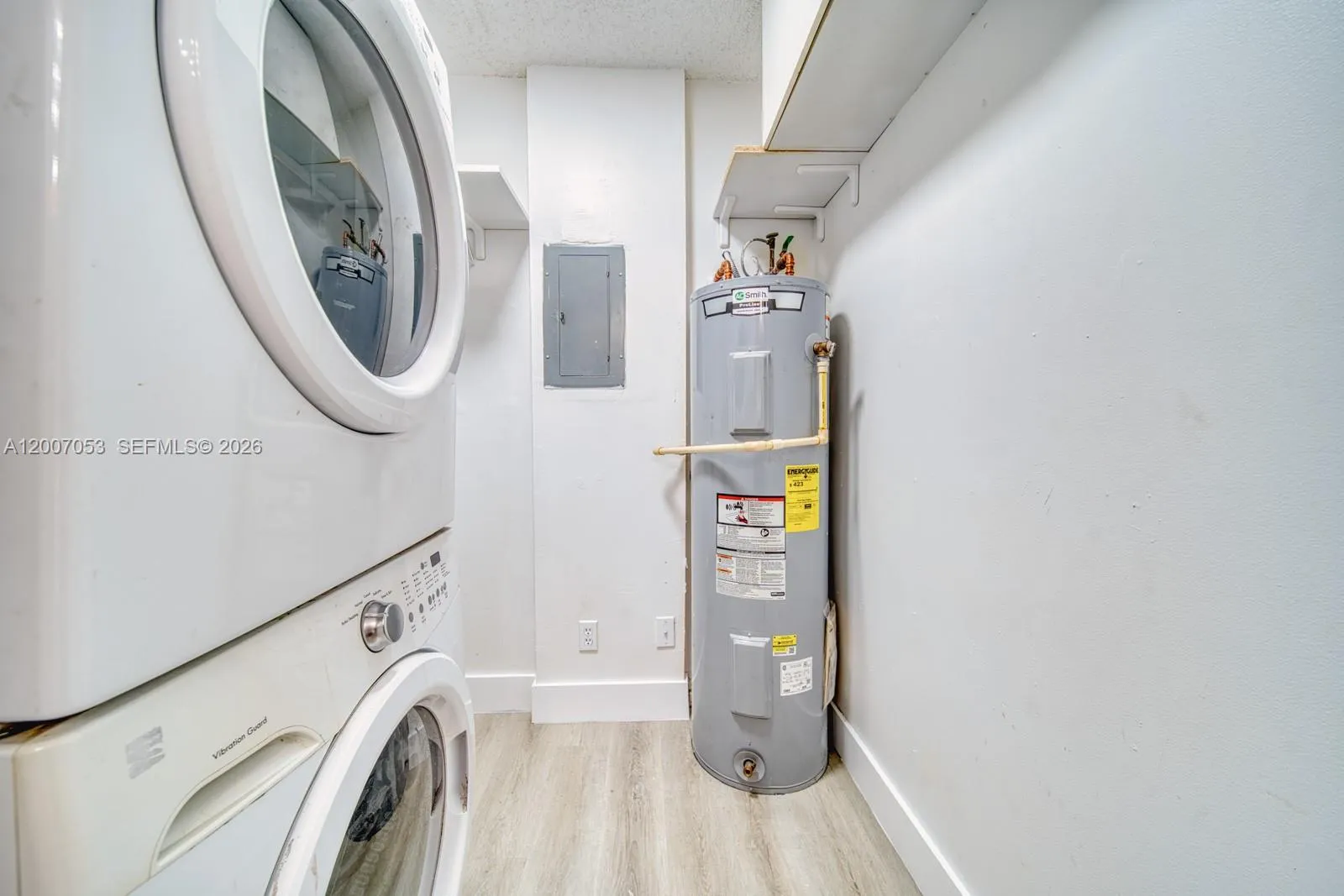 Adjacent to kitchen. Houses W/D, water heater, and plenty of room for storage.