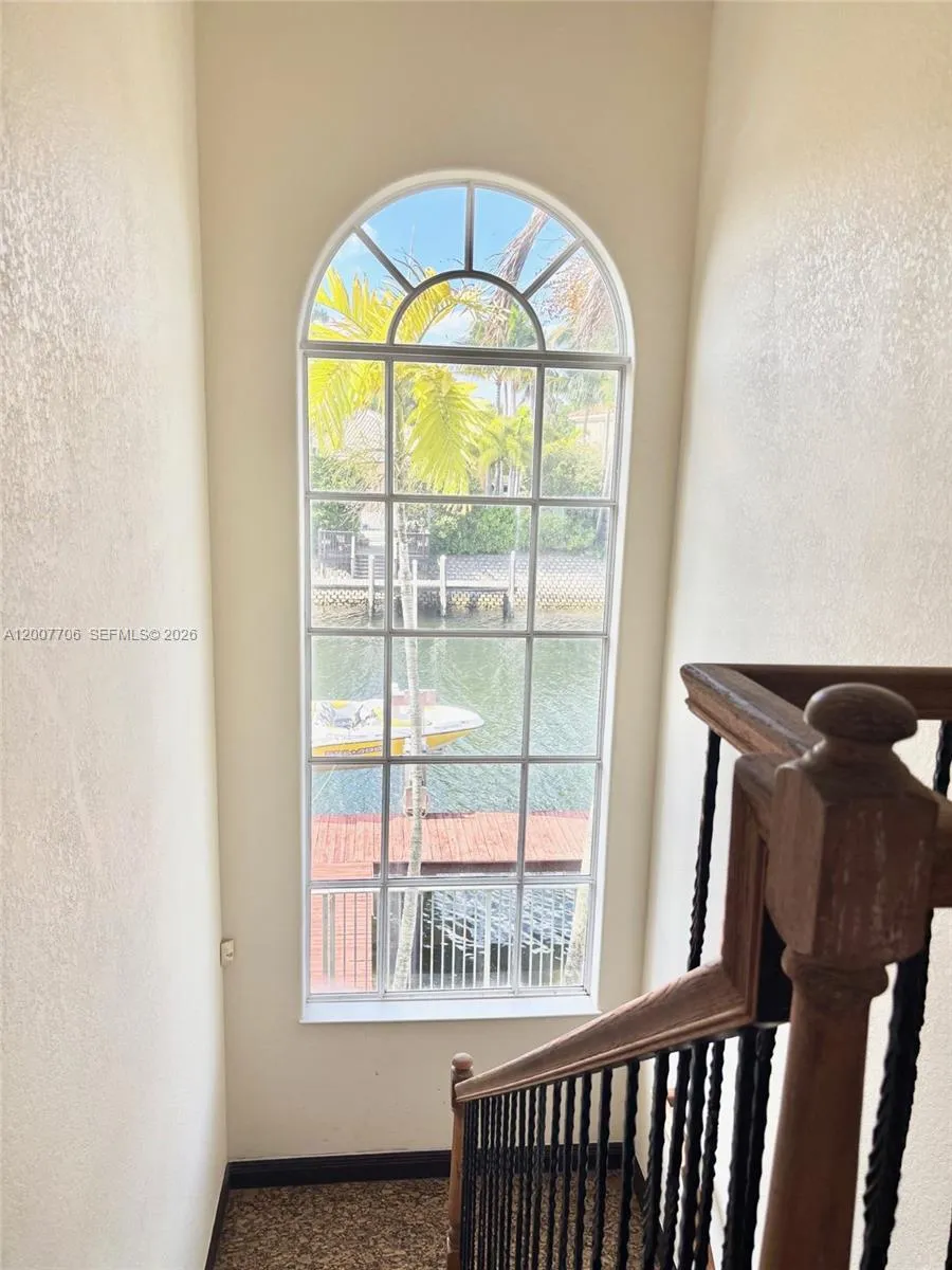 Huge window by staircase overlooking the water.