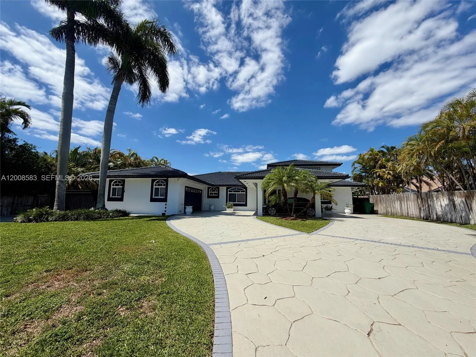 Left side of driveway and home