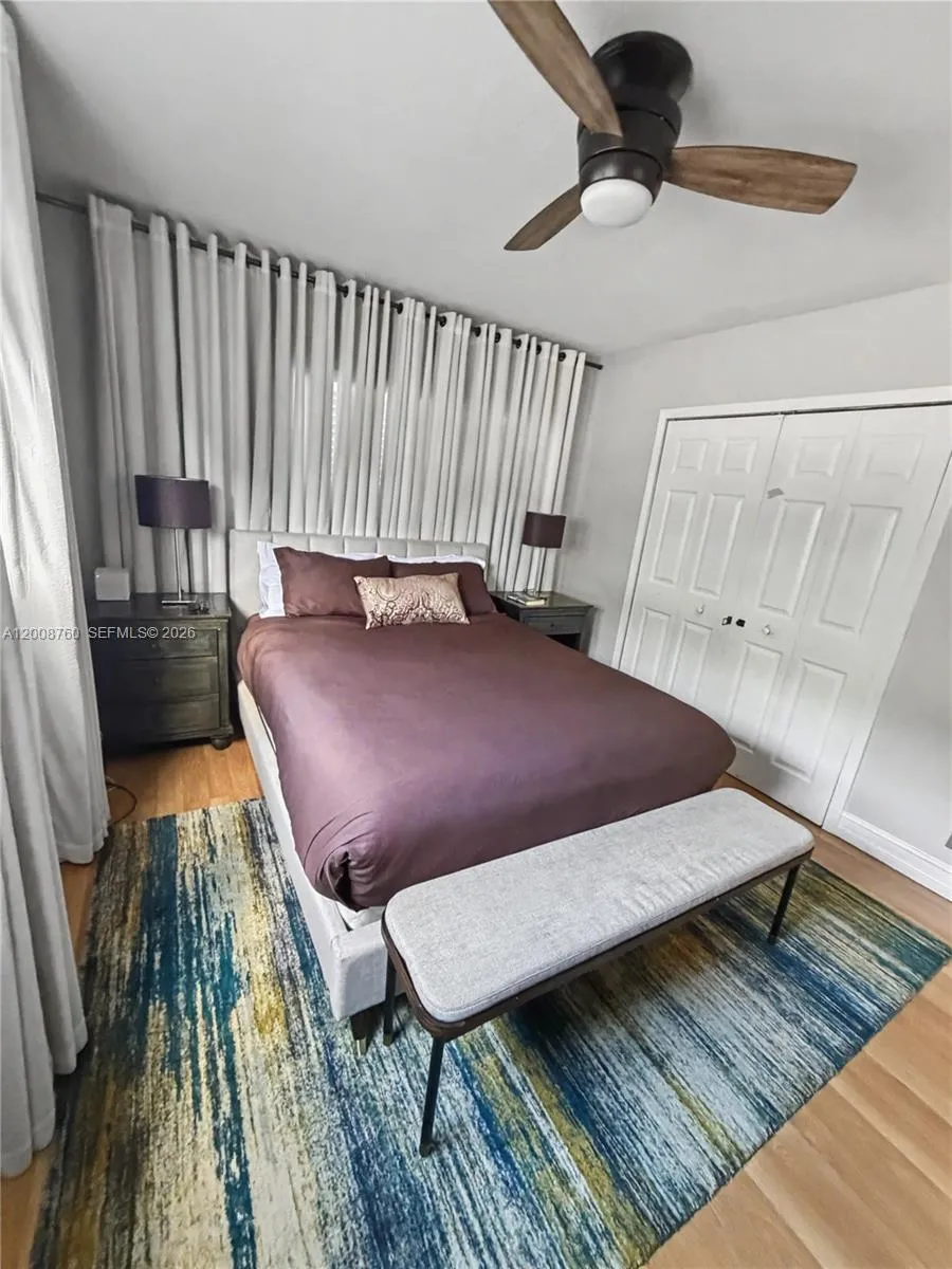 Primary bedroom — comfortable retreat with ceiling fan and quality finishes