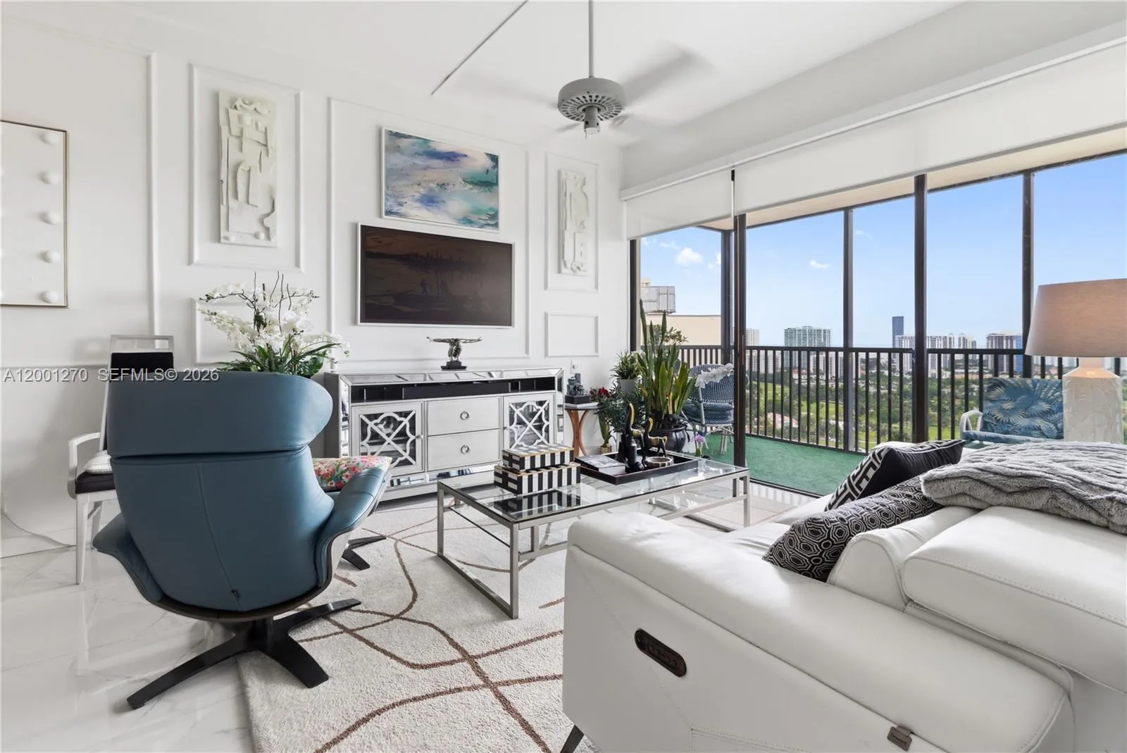 Bright living area with high ceilings and golf course views