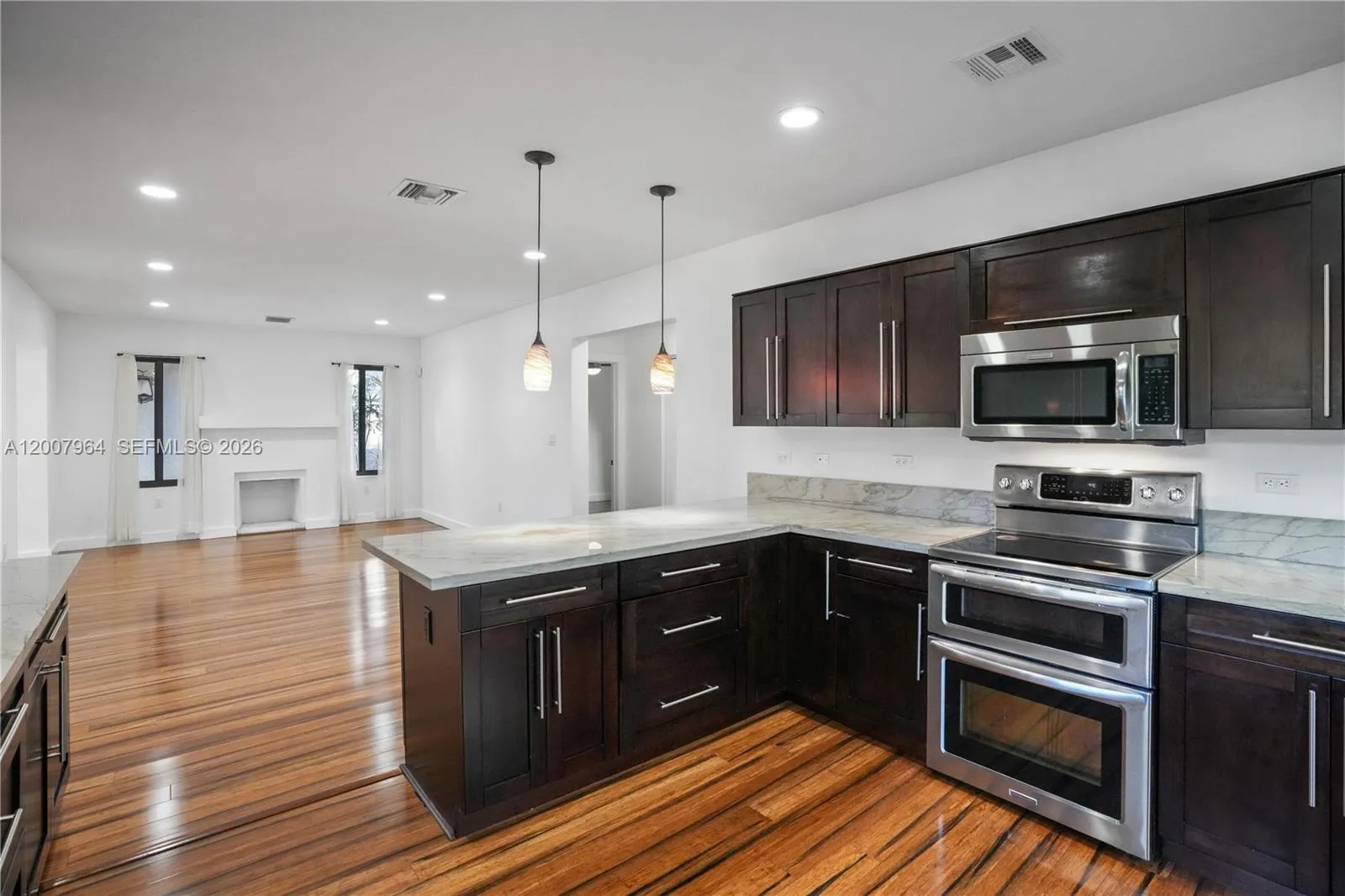 Large cooks kitchen open to the living room and dining room
