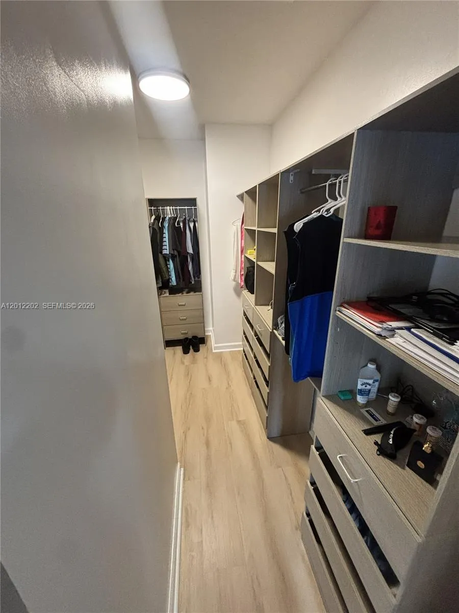 Master walk-in closet with built-in California Cabinets