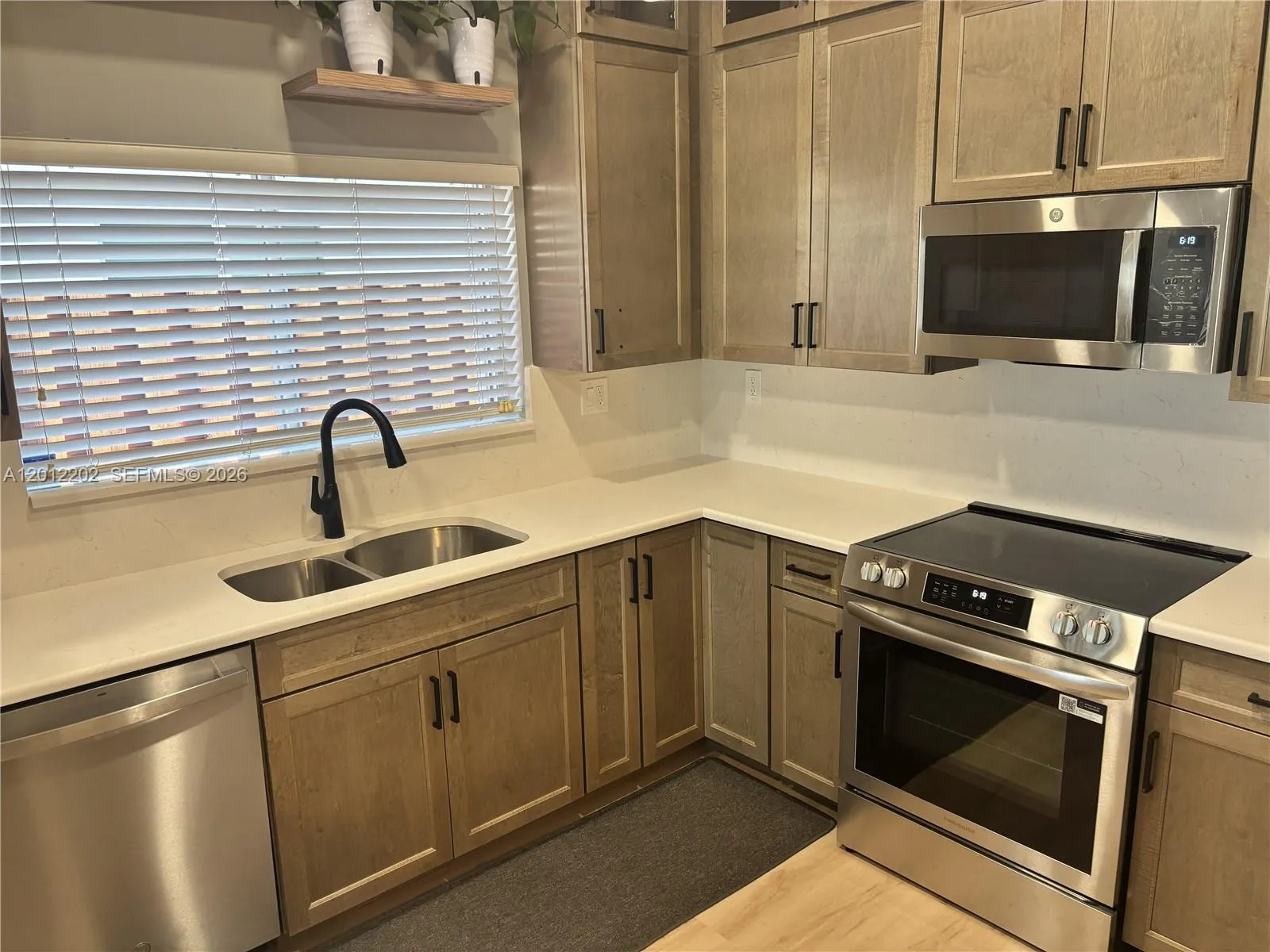Completely Remodeled Kitchen with Stainless Steel Appliances, Quartz Countertops and New Cabinetry.