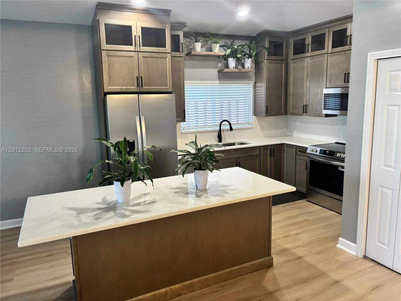 Completely Remodeled Kitchen with Stainless Steel Appliances, Quartz Countertops and New Cabinetry.