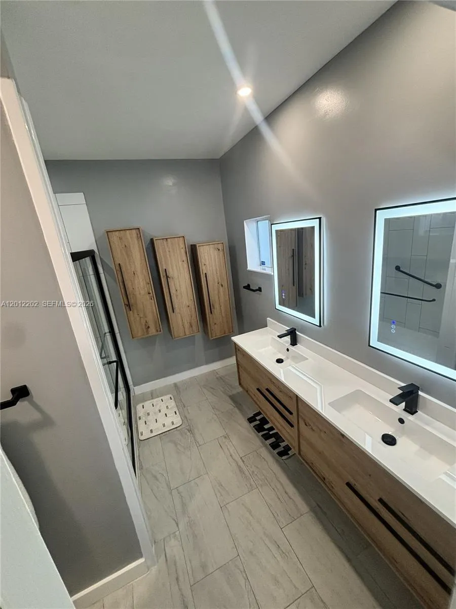 Renovated Master Bathroom with dual floating vanities.