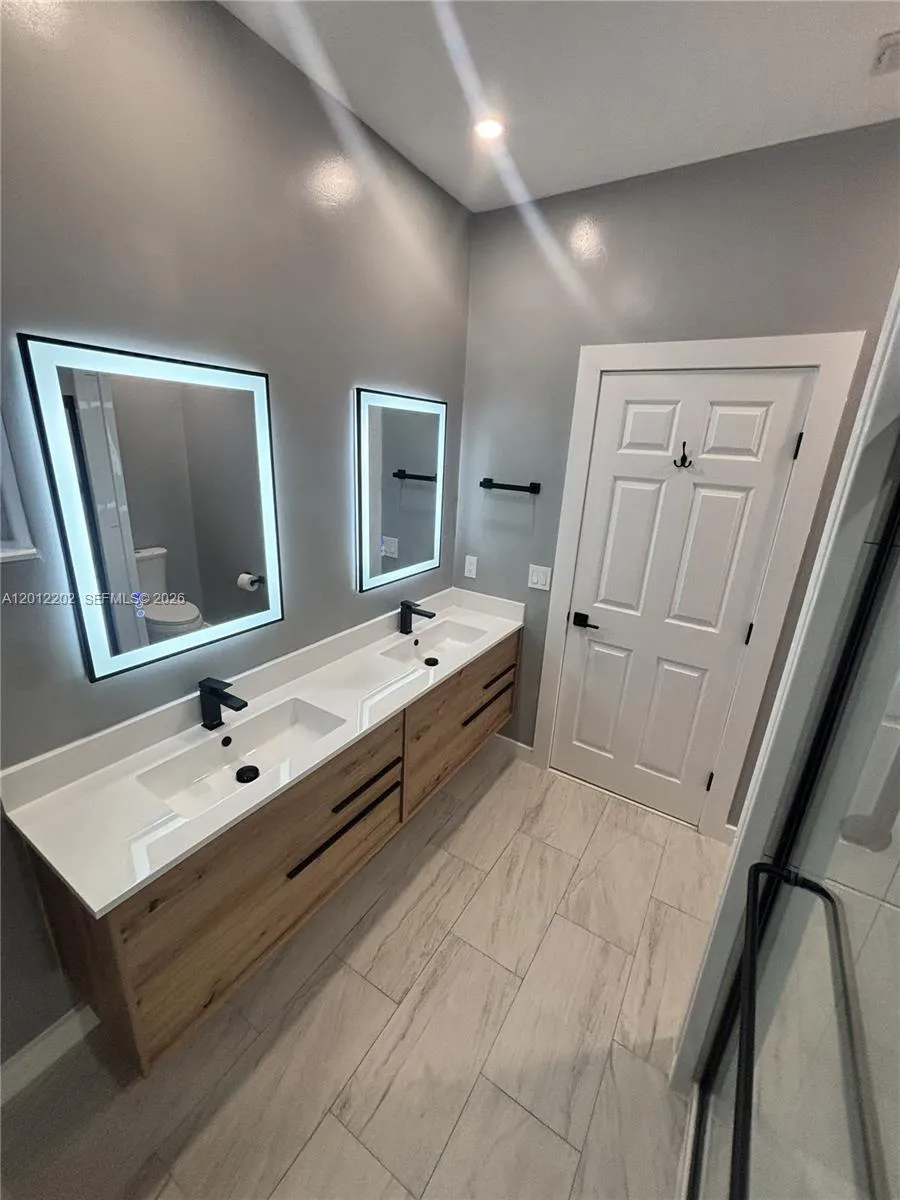 Renovated Master Bathroom with dual floating vanities.