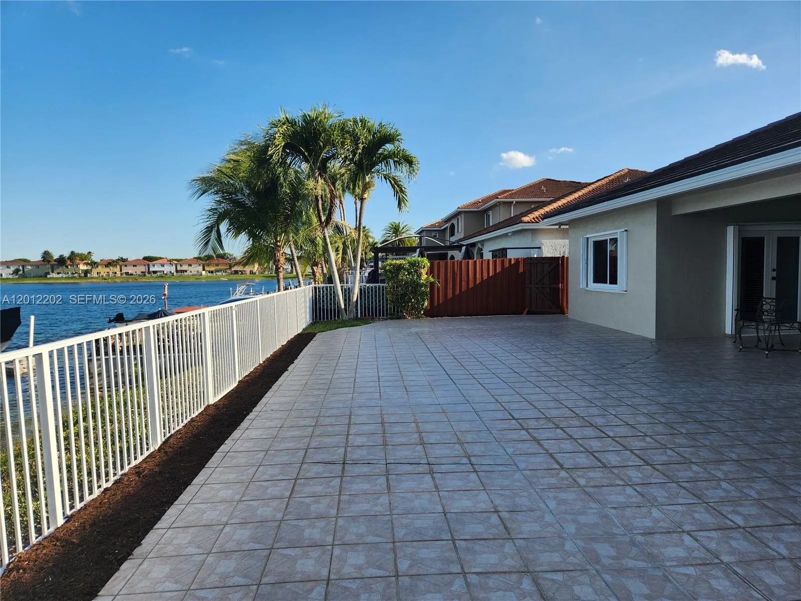 Spacious patio with a paradise view perfect for outdoor entertaining, including a covered area for more seating.