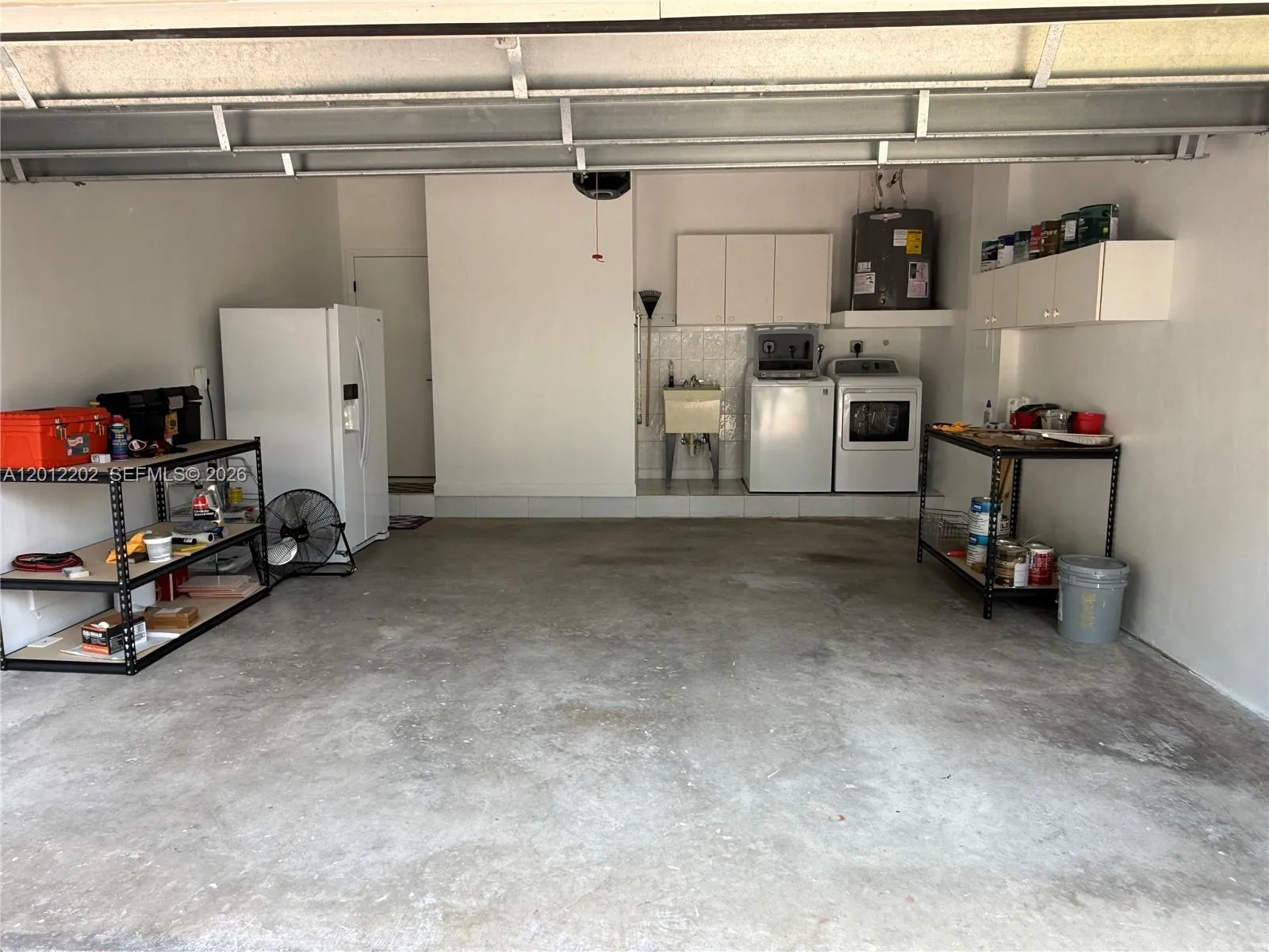 Two car garage with washer/dryer and laundry tub.