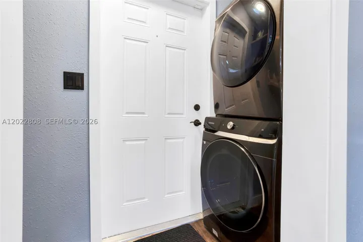 New full size washer and dryer, laundry area offering convenience and extra storage.