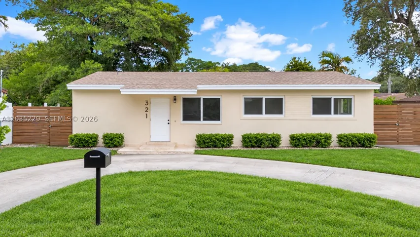 Front of Structure – Front view showcasing the home's new roof, updated windows, modern wood privacy fencing, and spacious front yard. AI-edited photograph for marketing purposes.