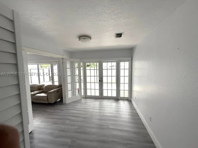 GROUND LEVEL ROOM WHICH CAN BE USED AS A BEDROOM OR OFFICE.