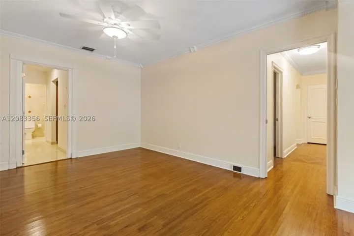 Primary Bedroom with Natural Wood Floors and Ensuite Access to Primary Bathroom