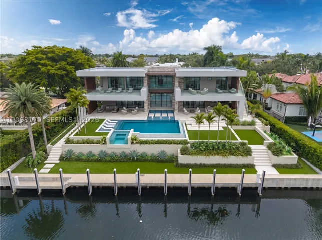 The proposed two-story estate offers approximately 7,845 square feet of air-conditioned living space — conceived around light, water and effortless indoor-outdoor living.
*Virtual staging inspired by Ramon Pacheco’s architectural renderings for the proposed residence. The property is offered with approved, shovel-ready plans.