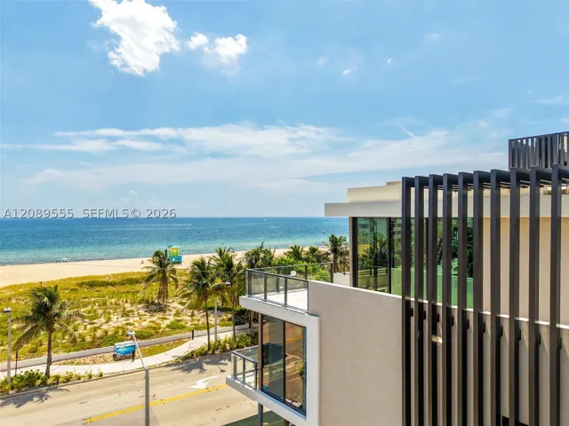 Louvered facade with the beach beyond.