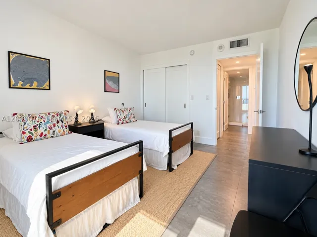 Bright guest room with custom built-in closet storage.