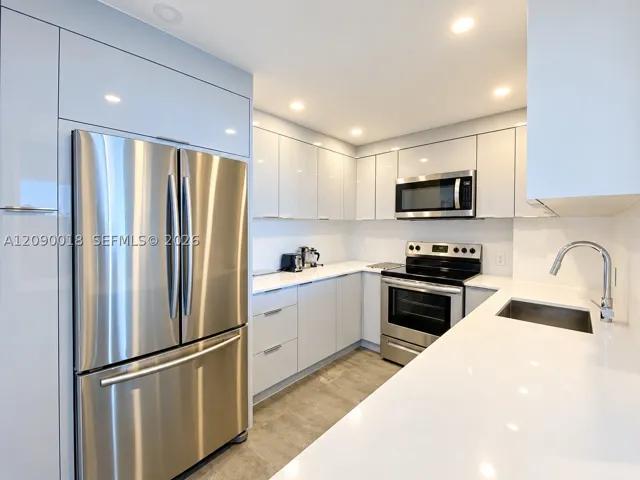 Stainless steel appliances and crisp white finishes.