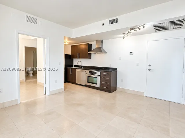 Bright and spacious open living area with clean tile flooring throughout.