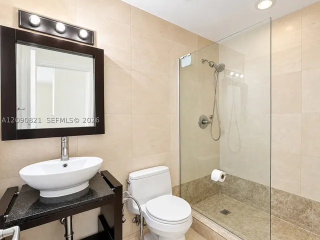 Updated bathroom with glass-enclosed shower, modern vanity, and sleek​​‌​​​​‌​​‌‌​‌‌​​​‌‌​‌​‌​‌​​​‌​​ lighting.
