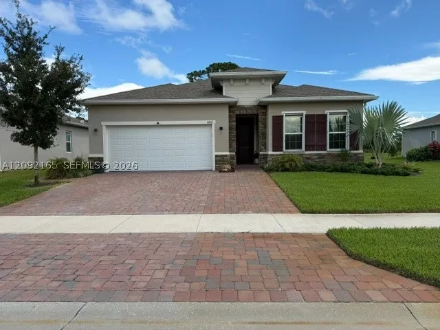 upgraded stone front and 3 car driveway