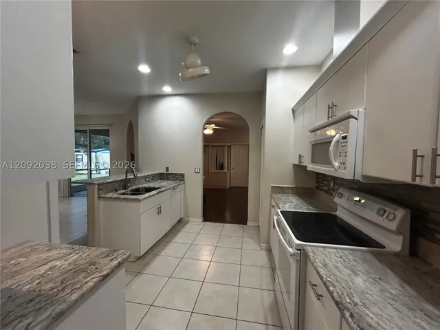 Refrigerator, electric stove, microwave, dishwasher, and pantry.