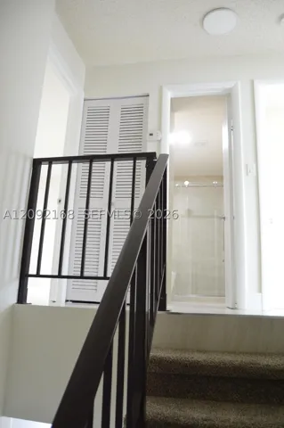 TOP OF THE STAIRS AND VIEW OF THE BATHROOM FOR 2ND AND 3RD BEDROOMS.
