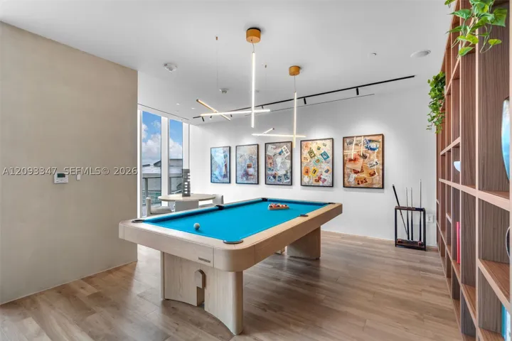 Game room with billiards table and curated residents art