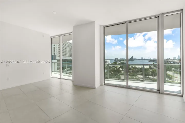 Corner living room with floor to ceiling glass and Biscayne Bay views