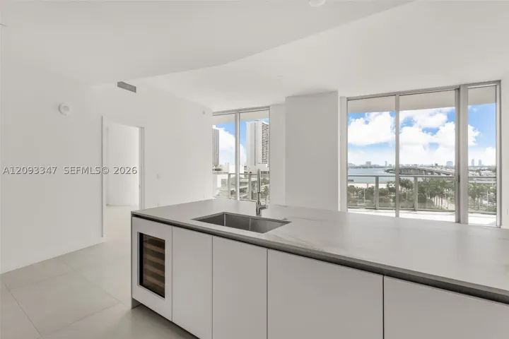 Kitchen island with integrated sink, wine cooler and open bay outlook