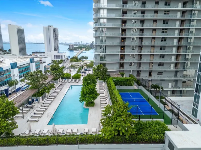 Amenity deck with lap pool and pickleball court above Biscayne Bay