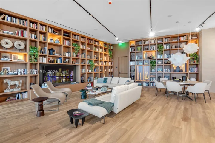 Residents library lounge with double height shelving and lounge seating