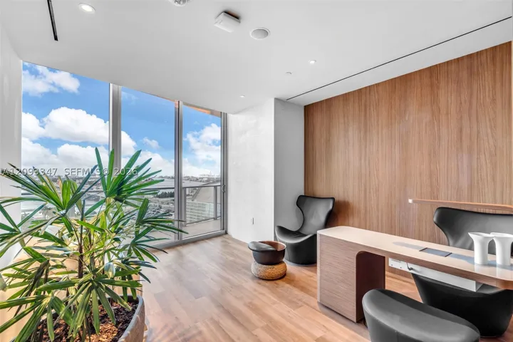 Private business suite with workstations and floor to ceiling glass