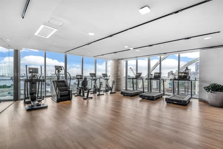 Fitness center with cardio equipment and bay facing glass