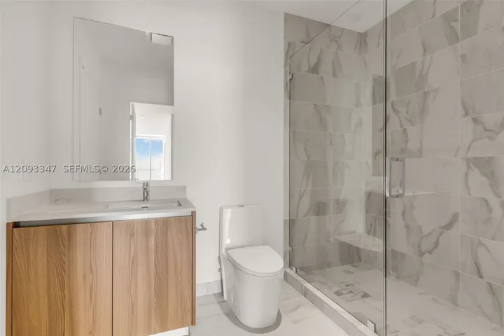 Second full bath with walk in shower and white oak vanity