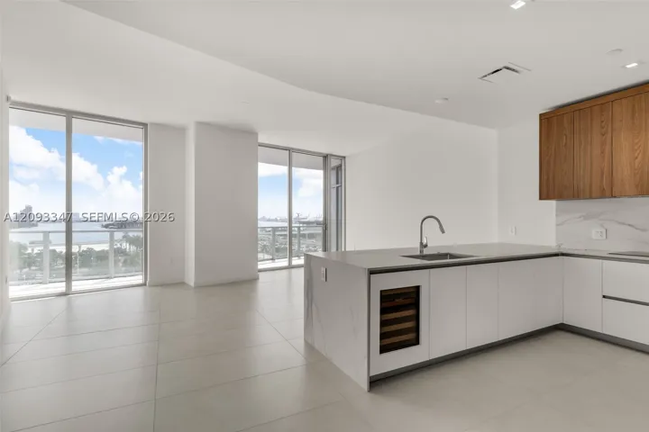 Open living and kitchen layout with 11 foot ceilings and bay views