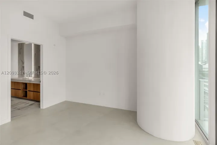 Primary bedroom with en suite bath and floor to ceiling windows